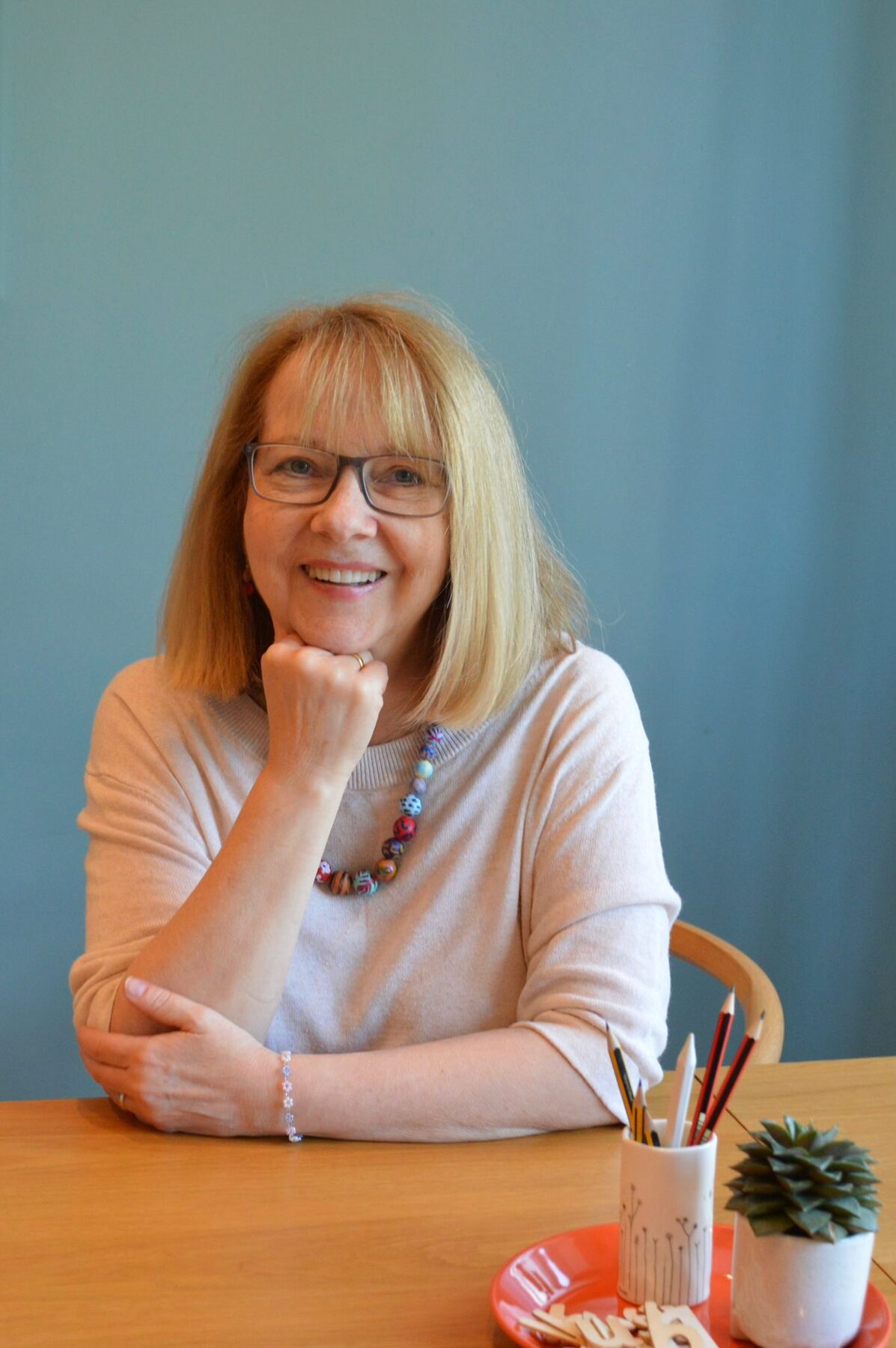Christine smiling at her desk