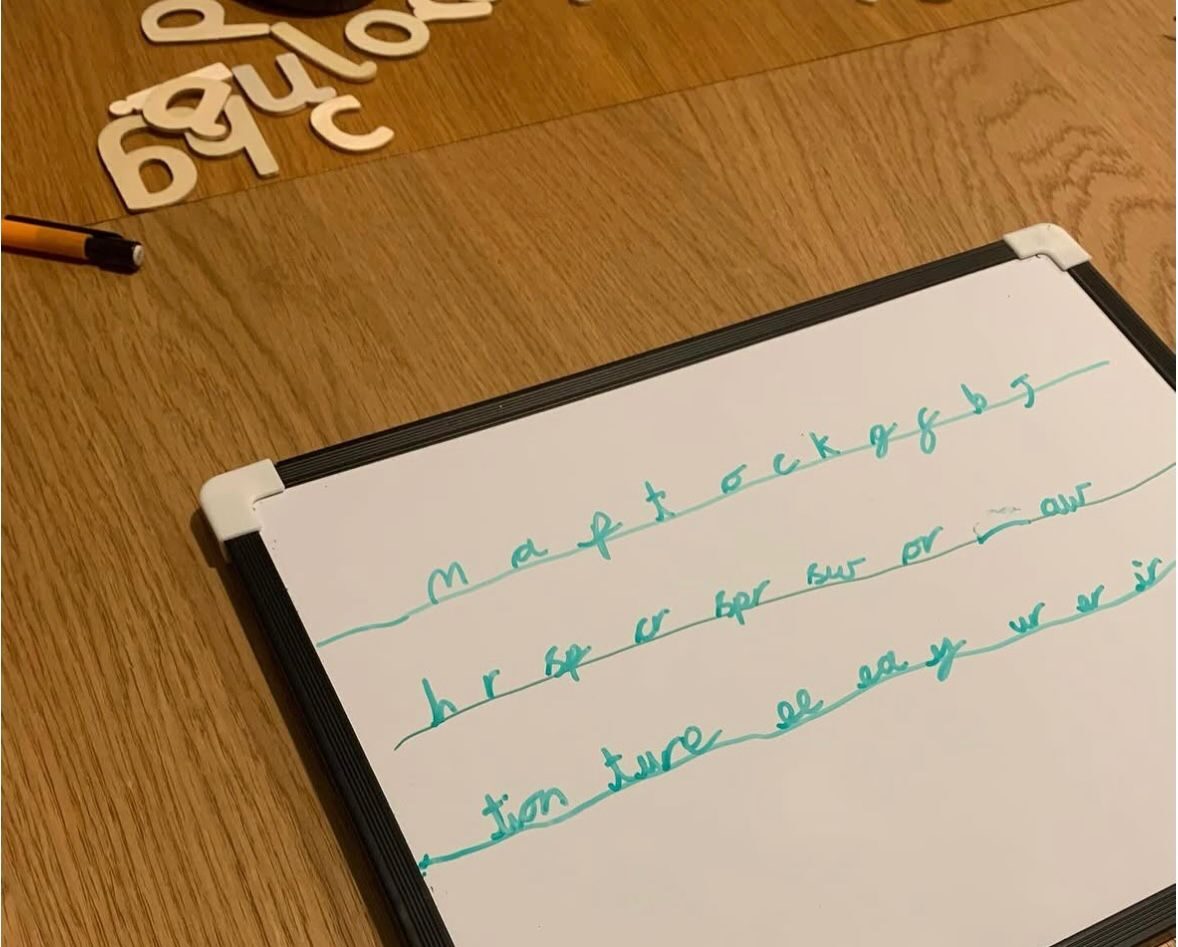 Handwriting practice on a whiteboard
